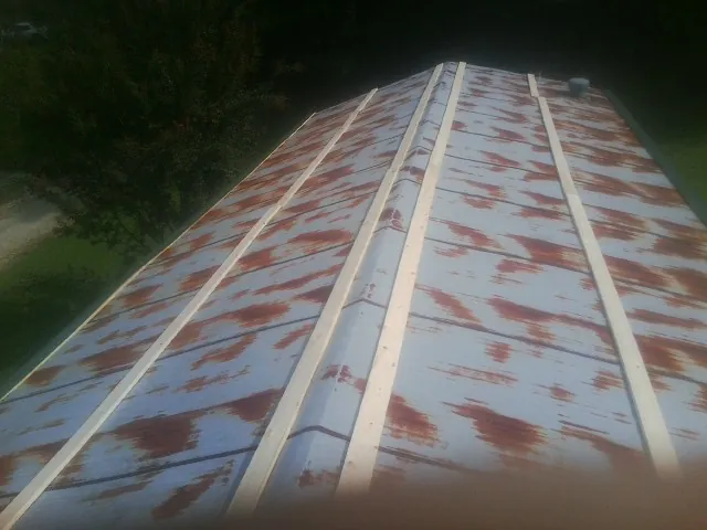 Rusted metal roof panels with new wood purlins before replacement — Storm Damage Roof Repair in Manhattan Beach by Roofing Brothers